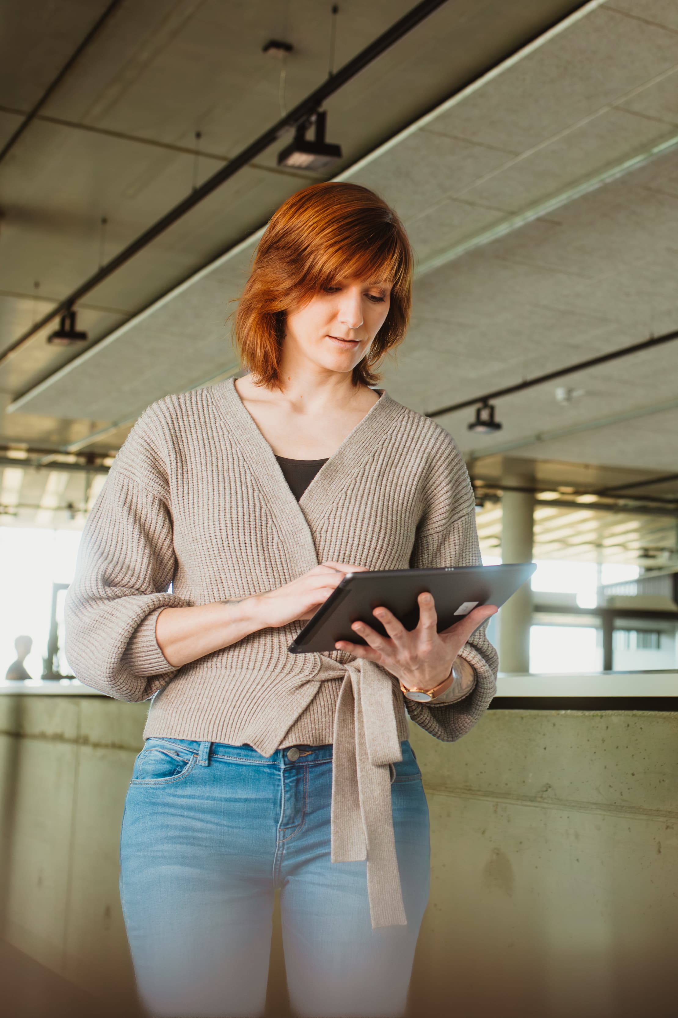 Mitarbeiterin nutzt ein Tablet in einem modernen Büro für das IT-Management