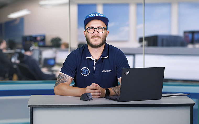 Dipendente IT con laptop in ufficio – DEX fornisce informazioni sulle prestazioni dei dispositivi e sul feedback degli utenti per una gestione efficiente